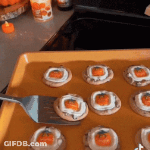 Person Holding Fork Over Tray Of Cookies GIF
