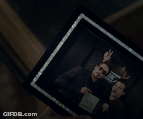 Person Holding Framed Picture Of Feet GIF