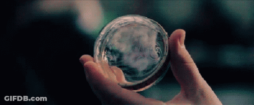 Person Holding Glass Ball With Smoke GIF