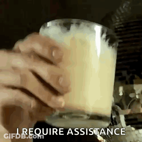 Person Holding Glass Of Milk With I Require Assistance GIF