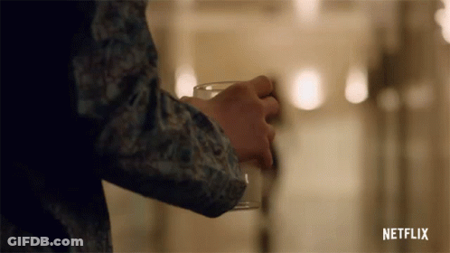 Person Holding Glass With Netflix GIF