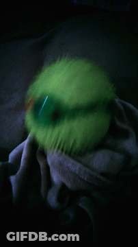 Person Holding Green Ball In Dark GIF