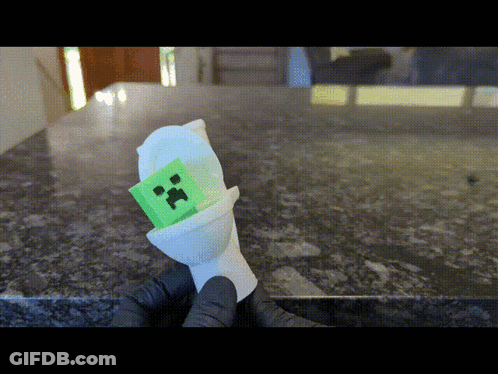 Person Holding Green Creeper In Toilet GIF