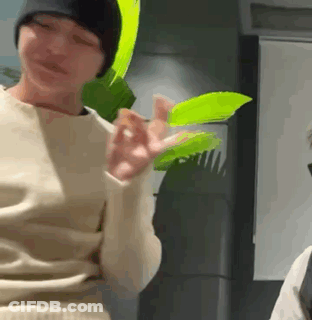 Person Holding Green Leaf In Beanie GIF