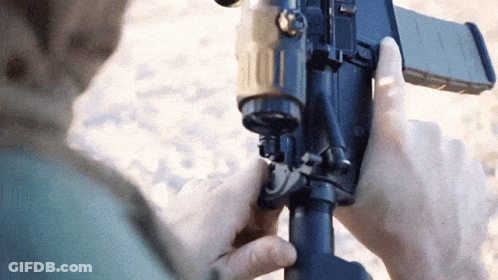 Person Holding Gun Close Up GIF