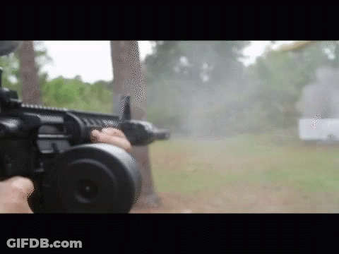 Person Holding Gun In Field GIF