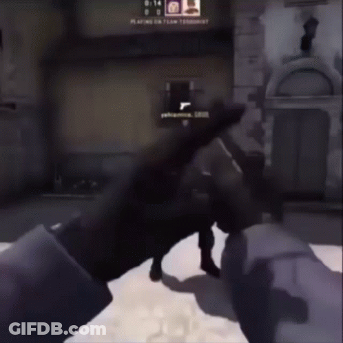 Person Holding Gun In Front Of Building Playing On GIF