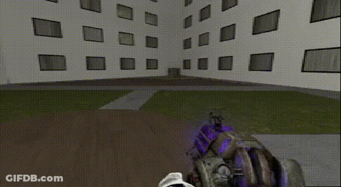 Person Holding Gun In Front Of Large Building GIF