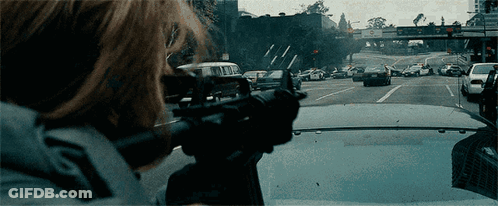 Person Holding Gun In Front Of Van GIF