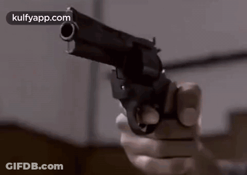 Person Holding Gun Pointing At Camera GIF