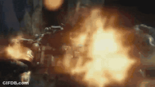 Person Holding Gun With Flames GIF