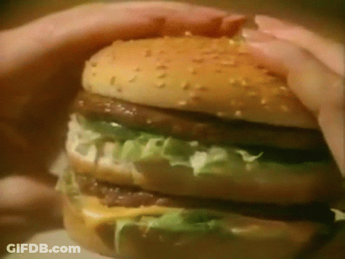 Person Holding Hamburger GIF