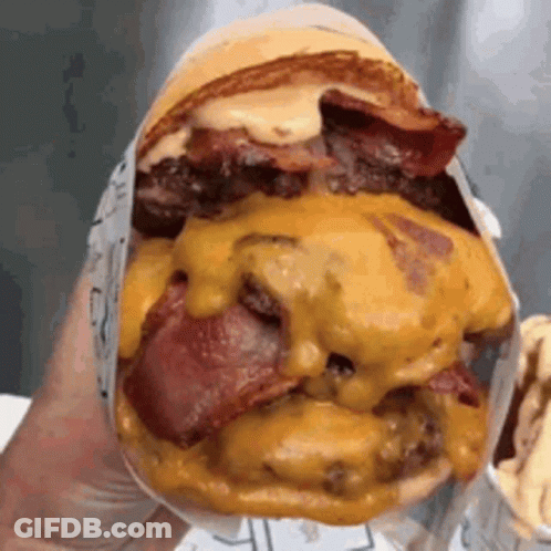 Person Holding Hamburger With Cheese Bacon And French Fries GIF