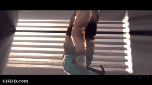 Person Holding Hammer In Front Of IGN Logo GIF