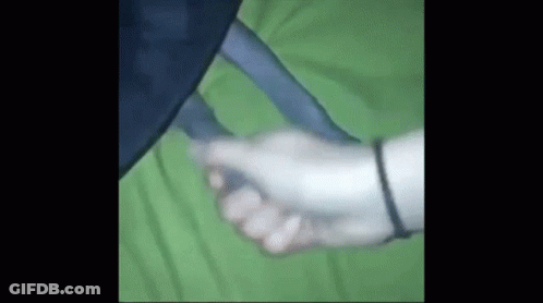 Person Holding Hand On Green Blanket GIF