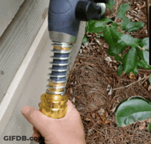 Person Holding Hose Near Wall GIF