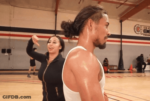 Person Holding Hot Dog In Front Of Food Tray GIF