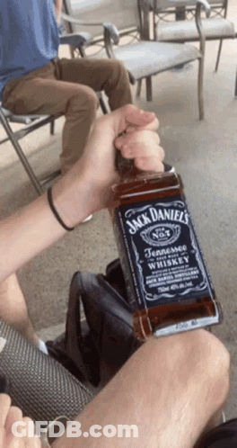 Person Holding Jack Daniels Bottle GIF