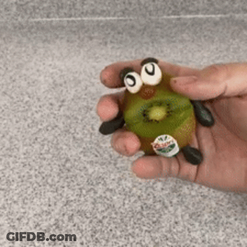 Person Holding Kiwi With Googly Eyes And Legs GIF