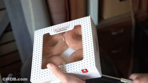 Person Holding Krispy Kreme Donuts GIF