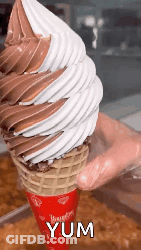 Person Holding Large Ice Cream Cone GIF