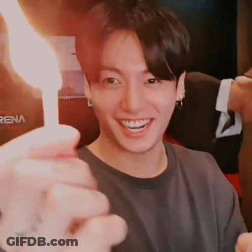 Person Holding Lit Candle Close Up GIF