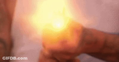 Person Holding Lit Candle GIF