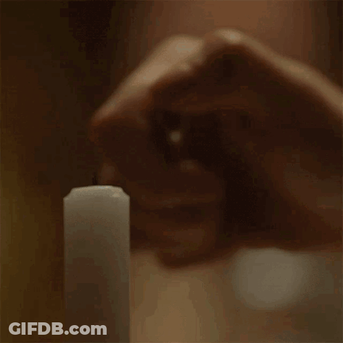 Person Holding Lit Candle GIF