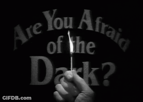 Person Holding Lit Match Saying Are You Afraid Of The Dark GIF