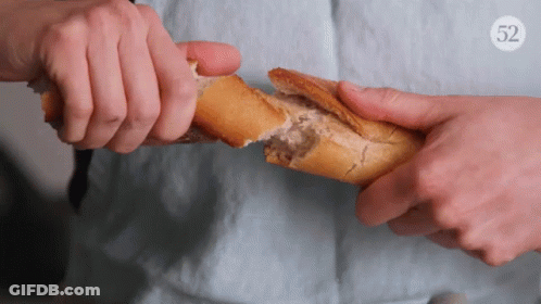 Person Holding Loaf Of Bread With Number 52 GIF
