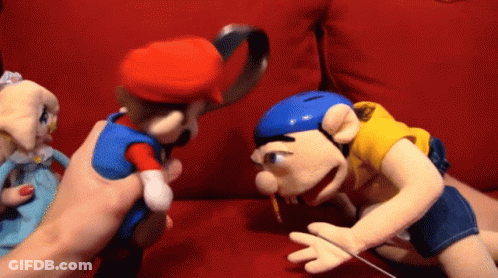Person Holding Mario Puppet And Jeff Puppet GIF