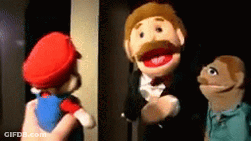 Person Holding Mario Puppet With Two Others Watching GIF