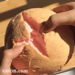Person Holding Melon With Slice Taken Out GIF