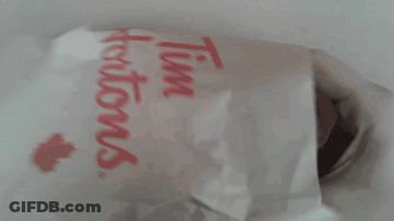 Person Holding Muffin Next To Tim Hortons Bag GIF