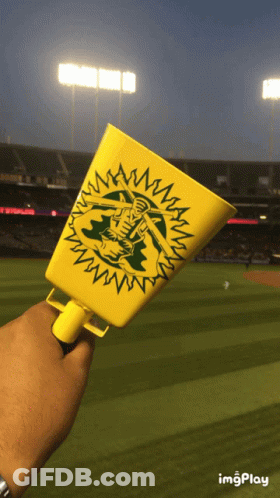 Person Holding Oakland Cup At Baseball Field GIF