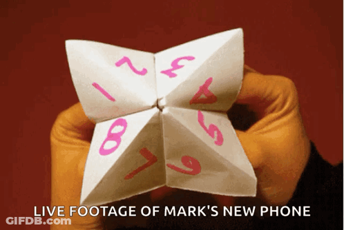 Person Holding Paper Fortune Teller With Live Footage Of Mark's New Phone GIF