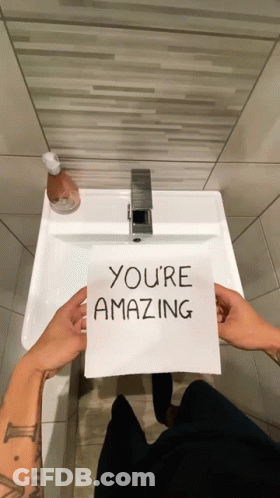 Person Holding Paper Saying You're Amazing GIF
