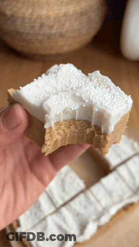 Person Holding Peanut Butter Fudge With White Frosting Sprinkles GIF