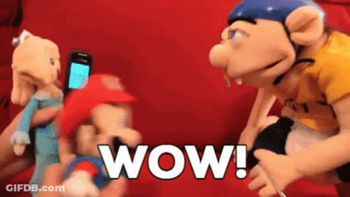 Person Holding Phone Beside Mario Puppet Wow GIF