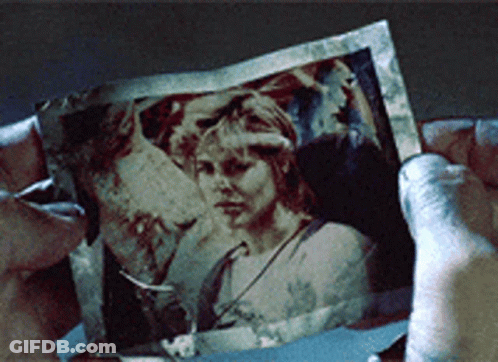 Person Holding Picture Of Woman's Face GIF