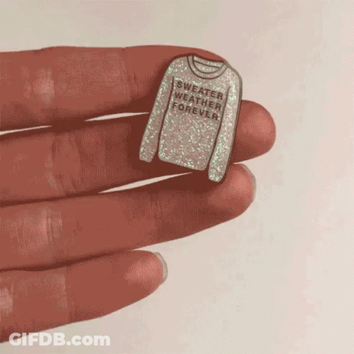 Person Holding Pin Saying Sweater Weather Forever GIF