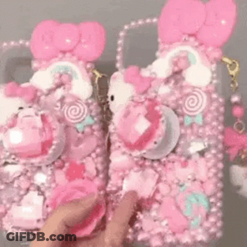 Person Holding Pink Hello Kitty Phone Case And Purse GIF