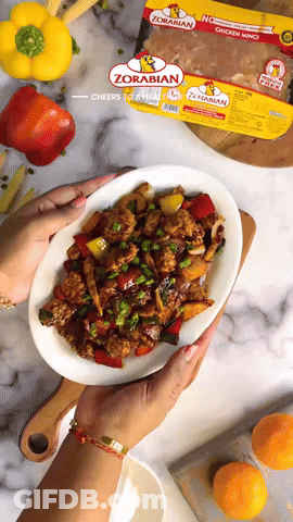 Person Holding Plate Of Food Next To Zorabian Chicken GIF