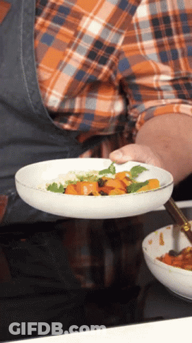 Person Holding Plate Of Food With Carrots And Rice GIF