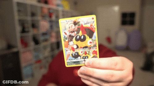Person Holding Pokemon Card With Yellow Pokemon GIF