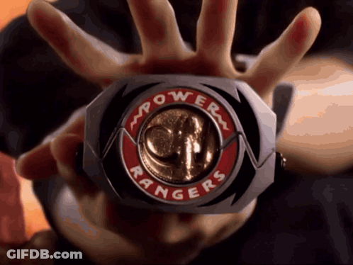 Person Holding Power Rangers Badge GIF