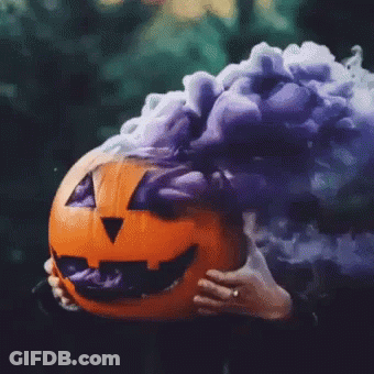 Person Holding Pumpkin With Purple Smoke GIF
