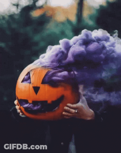 Person Holding Pumpkin With Purple Smoke GIF