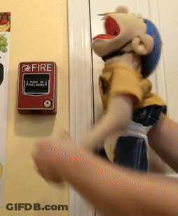 Person Holding Puppet At Fire Alarm GIF