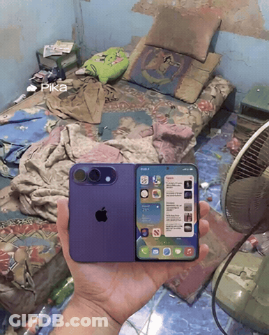 Person Holding Purple IPhone In Messy Bedroom GIF